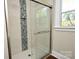 This modern shower features a sleek glass door, shower head, and a tiled inset at 506 E Ridge St, Kings Mountain, NC 28086