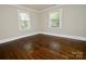 A cozy bedroom with hardwood floors and natural light from two windows creating a bright, welcoming space at 506 E Ridge St, Kings Mountain, NC 28086