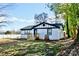 Charming one-story house with white-painted brick, black trim, and a newly built wooden porch and stairs at 506 E Ridge St, Kings Mountain, NC 28086