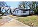 A white house features black trim and a nice yard; a garage apartment provides an optional living space at 506 E Ridge St, Kings Mountain, NC 28086