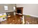 View of the living room with hardwood floors and a fireplace, offering a cozy and inviting atmosphere at 506 E Ridge St, Kings Mountain, NC 28086