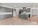 Open concept kitchen with grey cabinets, modern appliances, and a large center island at 5233 Glenwalk Dr # 0063, Charlotte, NC 28269