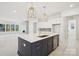 Modern kitchen with a large island, pendant lighting, and stainless steel appliances at 5233 Glenwalk Dr # 0063, Charlotte, NC 28269