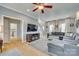 Open-concept living room with hardwood floors and comfortable gray sectional sofa at 550 S Portman Ln, Fort Mill, SC 29708