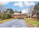 Expansive backyard featuring an in-ground pool with winter cover, brick house, and mature trees at 623 Spring Sw St, Concord, NC 28025