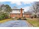 Expansive backyard with mature trees, brick house, and a pool covered with a winter cover at 623 Spring Sw St, Concord, NC 28025