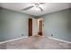 Empty bedroom features a ceiling fan, two windows, and an adjacent closet at 623 Spring Sw St, Concord, NC 28025