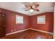 Inviting bedroom with wood floors, ceiling fan, and ample natural light from the two bright windows at 623 Spring Sw St, Concord, NC 28025