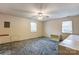 Spacious bedroom with neutral walls, plush carpet, and a ceiling fan with light fixture at 623 Spring Sw St, Concord, NC 28025