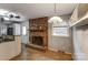 Charming dining room with brick fireplace, tiled floors, and adjacent kitchen space at 623 Spring Sw St, Concord, NC 28025
