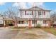 Charming two-story home featuring a large driveway, covered parking, and red brick and siding accents at 623 Spring Sw St, Concord, NC 28025