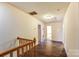 Hallway featuring wood trim and flooring, and multiple doorways leading to other rooms at 623 Spring Sw St, Concord, NC 28025