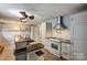 Bright kitchen featuring tile flooring, granite countertops, sleek range hood, and white cabinetry at 623 Spring Sw St, Concord, NC 28025