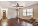 Inviting living room with shining wood floors, ceiling fan, and ample natural light from the front windows at 623 Spring Sw St, Concord, NC 28025