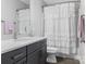Bathroom showcasing modern vanity with quartz countertop and a shower with a curtain at 7206 Sumters Camp Trl, Fort Mill, SC 29707