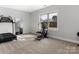 Neutral-toned bedroom providing space for at-home workout equipment and a full-length mirror at 7206 Sumters Camp Trl, Fort Mill, SC 29707