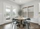 Cozy dining area with wooden table and chairs next to a screened-in porch at 7206 Sumters Camp Trl, Fort Mill, SC 29707