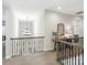 Upstairs hallway with view down to first floor, designer mirror and furniture at 7206 Sumters Camp Trl, Fort Mill, SC 29707