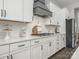 Well-lit kitchen featuring white cabinets, quartz countertops, and a modern gas range at 7206 Sumters Camp Trl, Fort Mill, SC 29707