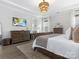 Spacious main bedroom with a large window, a decorative chandelier, and neutral colors at 7206 Sumters Camp Trl, Fort Mill, SC 29707
