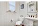 Cozy half-bathroom featuring modern fixtures, patterned wallpaper, and a bright window at 7560 Waverly Walk Ave, Charlotte, NC 28277