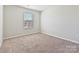 Cozy, carpeted bedroom bathed in natural light from a bright window, perfect for relaxation at 9021 Ramsford Ct, Mint Hill, NC 28227