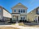 Charming two-story home featuring a welcoming front porch and manicured landscaping at 9021 Ramsford Ct, Mint Hill, NC 28227