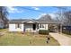 Charming single-story home with a carport, small porch, and manicured front yard at 909 Laye St, Belmont, NC 28012