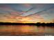 Sunset view over a lake with vibrant orange and pink hues reflecting on the water at 9709 Emerald Point Dr # 2, Charlotte, NC 28278