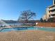 Community pool with brick surround, lake view, and lakeside access at 9709 Emerald Point Dr # 2, Charlotte, NC 28278