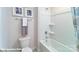 Bathroom features a toilet, framed art, and a shower-tub combo with shelving and neutral curtain at 106 Woodhall Way, Troutman, NC 28166