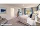 The main bedroom features a large window, a tufted headboard and a comfortable chair at 106 Woodhall Way, Troutman, NC 28166