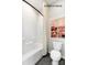 Clean bathroom featuring white tiling in shower-tub combination, a modern toilet, and neutral abstract wall art at 11016 Tyler Brook Ln # Oak0036, Mint Hill, NC 28227