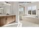 Bright bathroom features a soaking tub, tiled shower, and double vanity with stone countertops at 11016 Tyler Brook Ln # Oak0036, Mint Hill, NC 28227