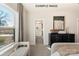 Sunlit bedroom with plush seating area, dresser, and ensuite bathroom access at 11016 Tyler Brook Ln # Oak0036, Mint Hill, NC 28227