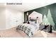 Stylized bedroom with green accent wall, tree decals, and natural light streaming through the windows at 11016 Tyler Brook Ln # Oak0036, Mint Hill, NC 28227