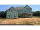 New construction home exterior featuring wrapped walls, windows, and architectural roofing at 11016 Tyler Brook Ln # Oak0036, Mint Hill, NC 28227