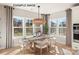 Sun-filled dining room featuring bright windows, modern light fixtures, and a hardwood floor at 11016 Tyler Brook Ln # Oak0036, Mint Hill, NC 28227