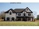 Beautiful two-story home featuring a large front yard and eye-catching black and white trim at 11016 Tyler Brook Ln # Oak0036, Mint Hill, NC 28227