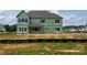 View of a two-story new construction with exposed sheathing and windows on a spacious lot at 11016 Tyler Brook Ln # Oak0036, Mint Hill, NC 28227
