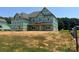 Exterior view of a house being built with a covered porch and windows installed at 11016 Tyler Brook Ln # Oak0036, Mint Hill, NC 28227