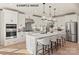 Modern kitchen with white cabinets, quartz countertops, stainless steel appliances, and large island at 11016 Tyler Brook Ln # Oak0036, Mint Hill, NC 28227