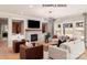 Cozy living room with a stone fireplace, built-in cabinets, large windows, and comfortable seating at 11016 Tyler Brook Ln # Oak0036, Mint Hill, NC 28227