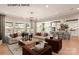 Bright open-concept living room with modern lighting, hardwood floors, and large windows showcasing the outdoor scenery at 11016 Tyler Brook Ln # Oak0036, Mint Hill, NC 28227