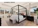 Serene main bedroom with a canopy bed, modern lighting, and large windows, creating a relaxing retreat at 11016 Tyler Brook Ln # Oak0036, Mint Hill, NC 28227