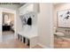 Convenient mudroom with built-in bench and storage, adjacent to a well-lit entryway and a view of the bathroom at 11016 Tyler Brook Ln # Oak0036, Mint Hill, NC 28227