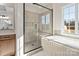 Bright bathroom features a glass shower, a soaking tub, and a white marble floor at 11016 Tyler Brook Ln # Oak0036, Mint Hill, NC 28227