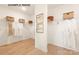 Spacious walk-in closet with wood floors, wire shelving, and ample storage space at 11016 Tyler Brook Ln # Oak0036, Mint Hill, NC 28227
