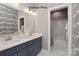 Elegant bathroom with blue vanity featuring double sinks and a shower/tub combo at 11020 Tyler Brook Ln # Oak0035, Mint Hill, NC 28227