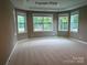 Light-filled bedroom with neutral paint, a tray ceiling, and lush views outside at 11020 Tyler Brook Ln # Oak0035, Mint Hill, NC 28227